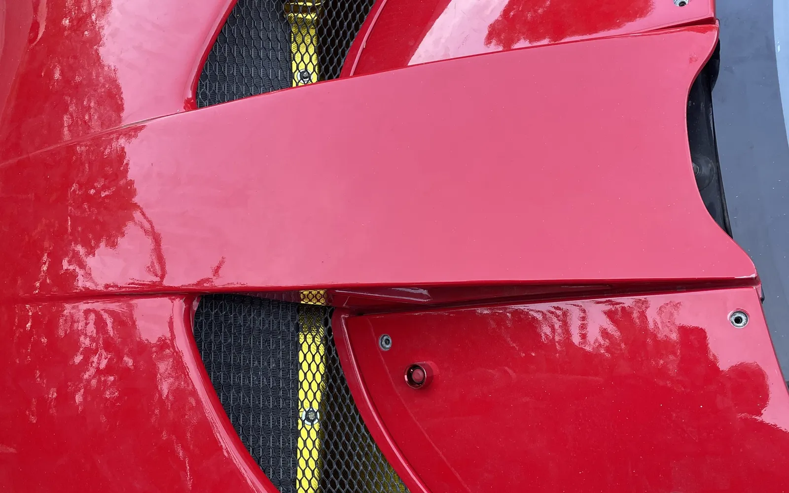 Bodywork detail of a red Lotus with cooling vents