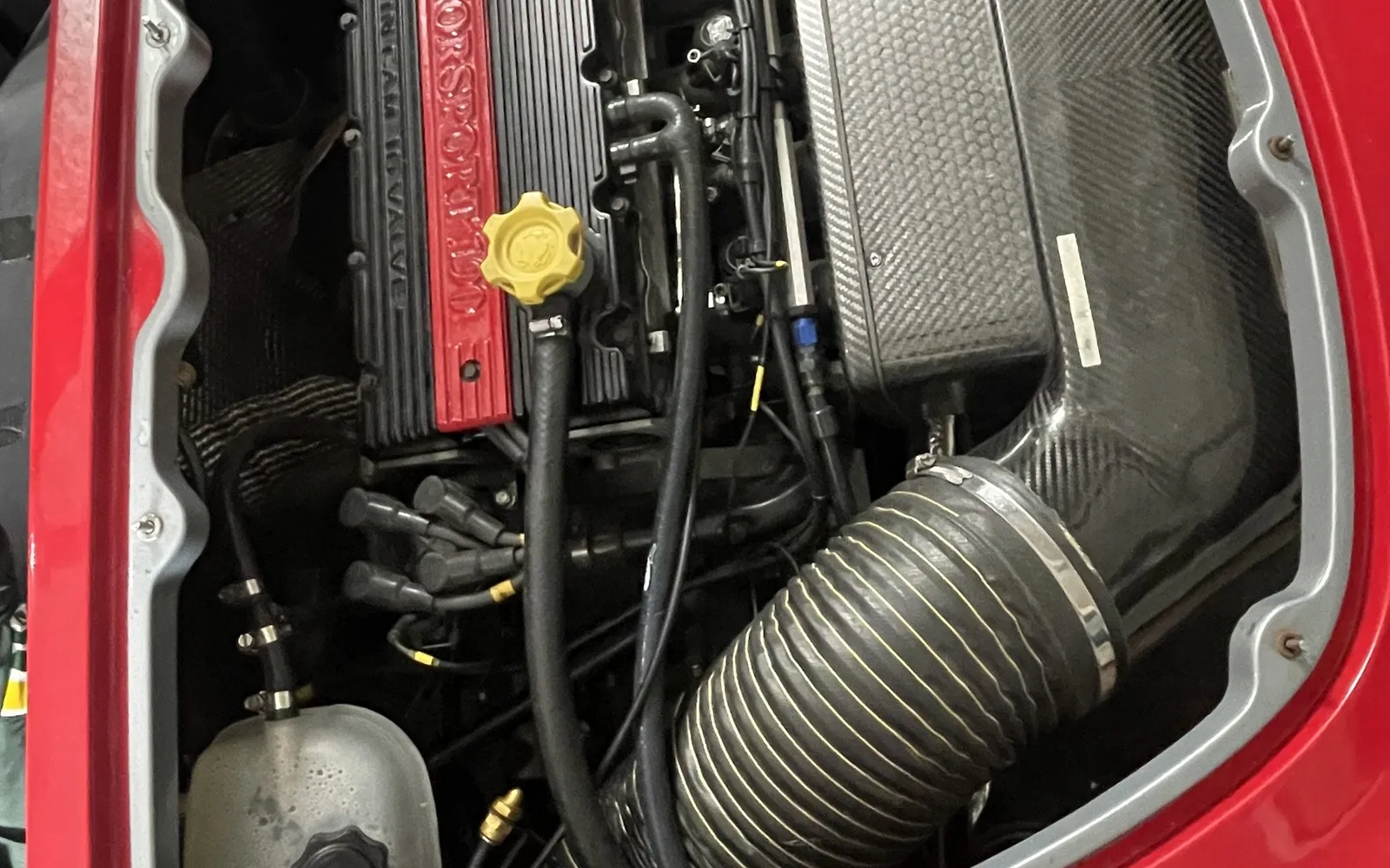 Open engine bay of a red Lotus